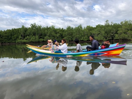 Locals take tourists on a local hidden fishermans trail excursion in Khao Lak, Thailand as part of CBT