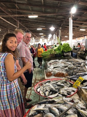 Shopping at a local food market in Khao Lak, Thailand to keep the tourism dollar local and minimise tourism leakage.