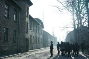 a photo of group in front of Auschwitz's buildin