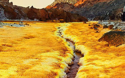 Natural saffron-colored crystals and the golden color river